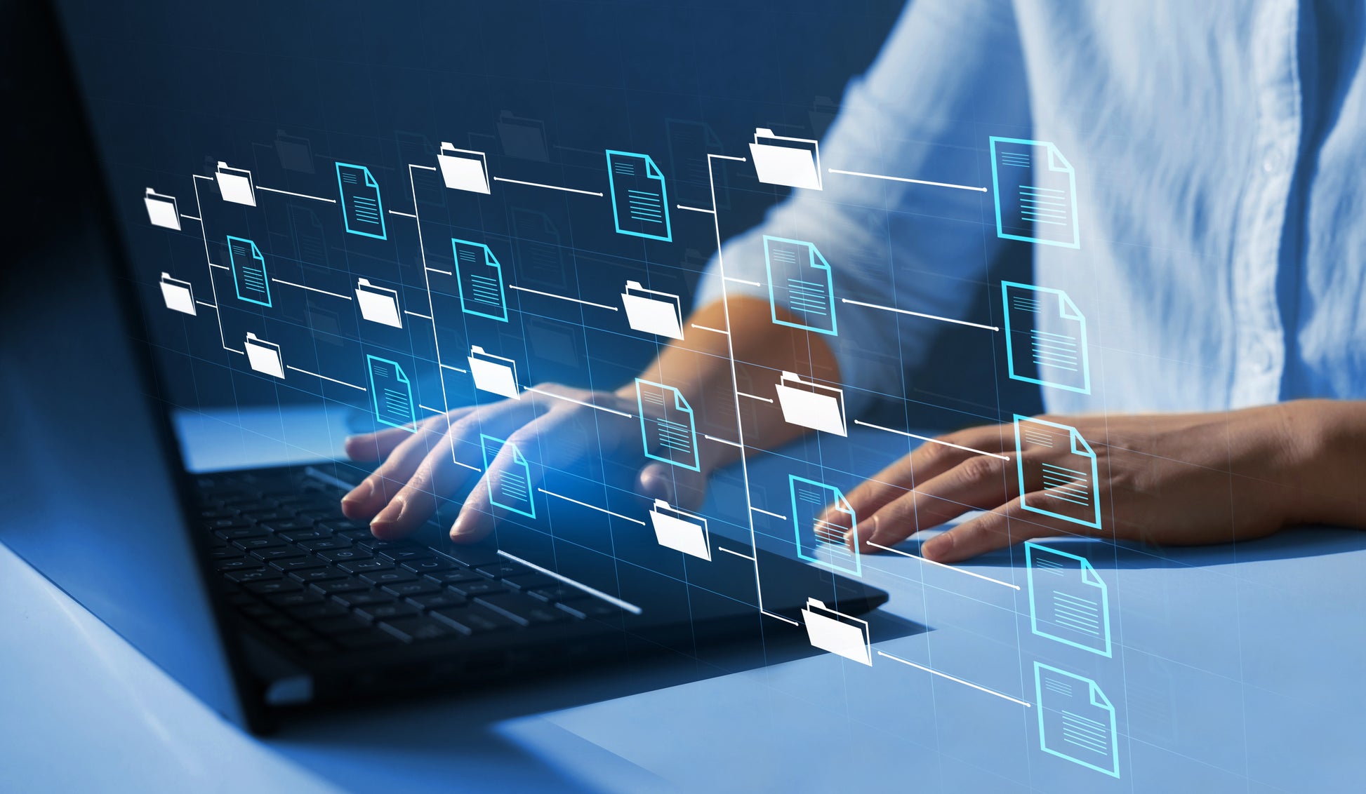 person working on laptop with data files