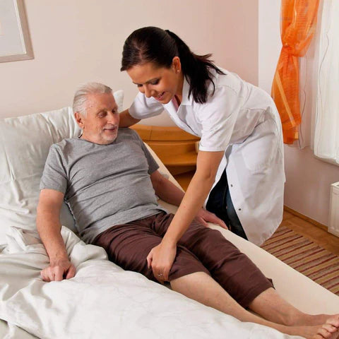 Nurse assisting elderly man with manual tasks
