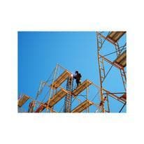 Construction worker welding on scaffolding.