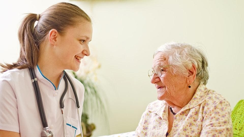 Nurse assisting senior with medication