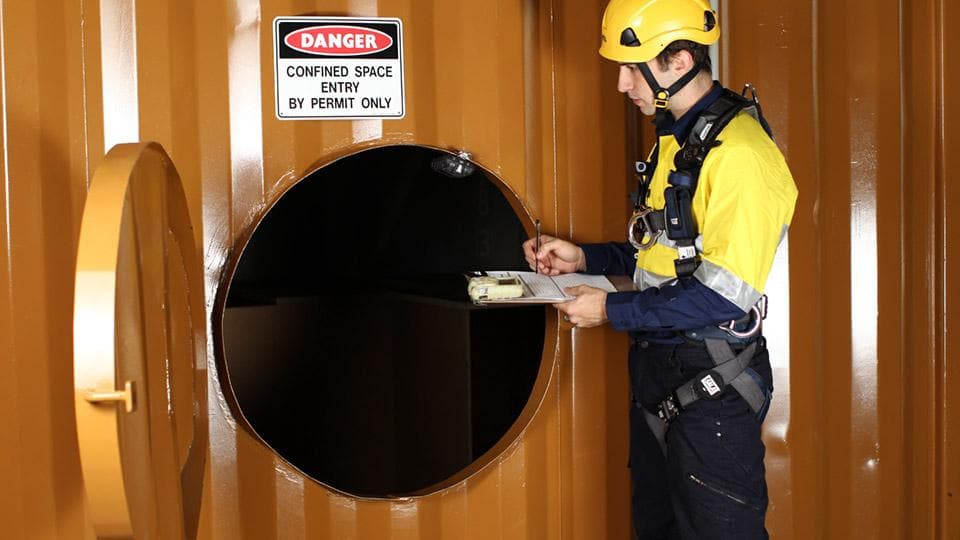 Confined space entry permit check, as per hazard guide, with worker.