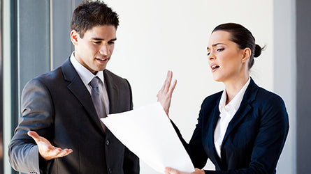 Business colleagues arguing over document