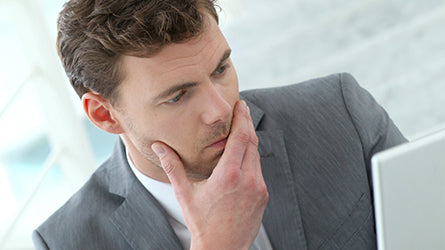 Man in suit reviewing personal performance and development