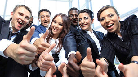 Team celebrating successful performance with thumbs up