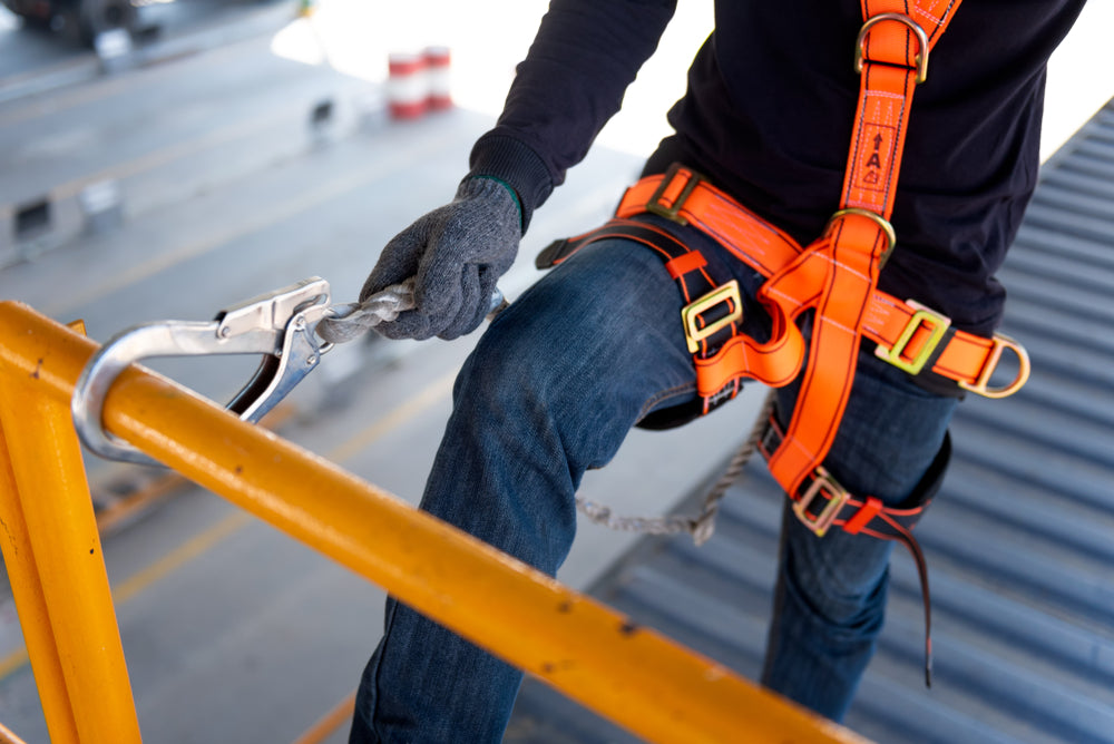 Worker in safety harness.
