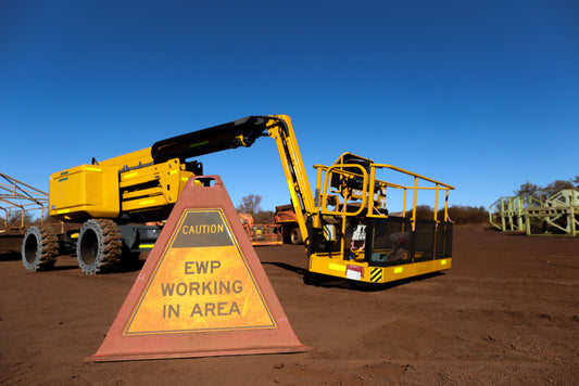 Yellow boom lift with EWP warning sign