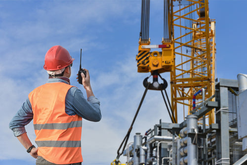 worker using radio near crane