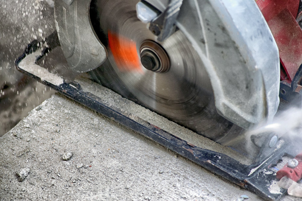 Concrete being cut with a circular saw